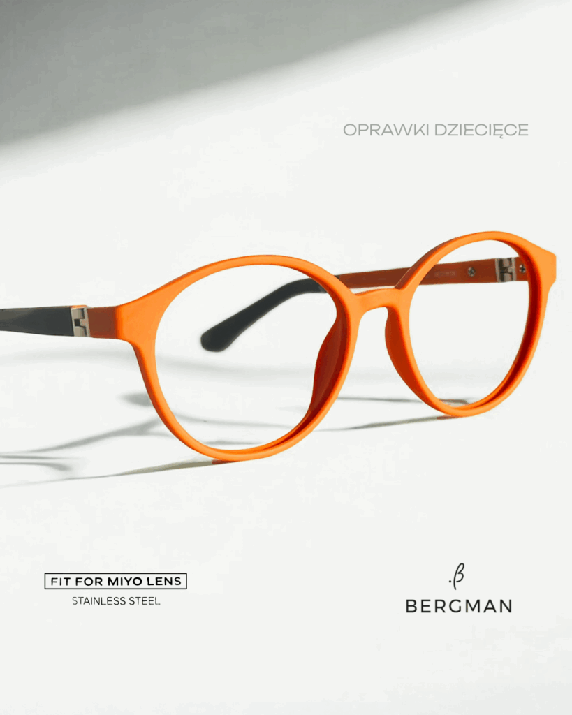 Pomarańczowe dziecięce oprawki Bergmann w okrągłym kształcie, kompatybilne ze szkłami MiYOSMART, na jasnym tle.